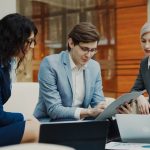Three business people collaborating on a project