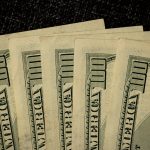 a close up of a bunch of money on a table