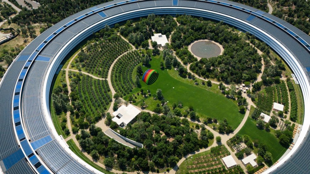 An aerial view of a circular building surrounded by trees