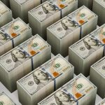 Stacks of $100 bills are neatly arranged.